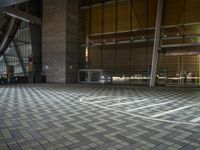 an empty hall with glass walls and windows, floor to ceiling carpeting and stairs