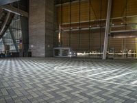 an empty hall with glass walls and windows, floor to ceiling carpeting and stairs