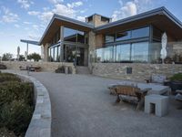 the building is built on two levels by stone walls and features a large outdoor space