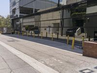 a sidewalk with benches on it and a building reflecting in the glass back wall and windows