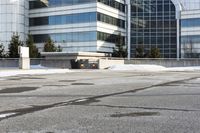 the building is next to a garbage can and snow on the ground area of the courtyard