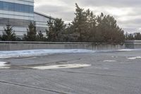 the building is next to a garbage can and snow on the ground area of the courtyard