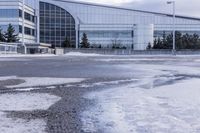 a street sign is sitting in the middle of an empty parking lot outside a building