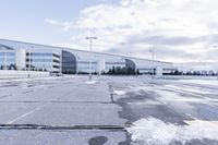 a street sign is sitting in the middle of an empty parking lot outside a building