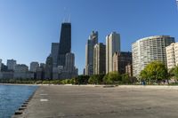 a group of tall buildings sit on the water's edge, in this photograph