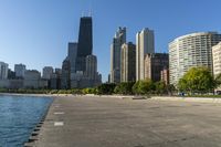 a group of tall buildings sit on the water's edge, in this photograph