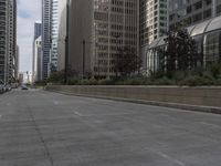 city buildings are along a quiet road with a signpost to point out the lights