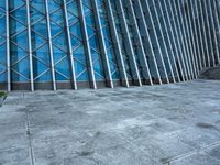 a building with several sections in the middle of it and a person standing outside on the side