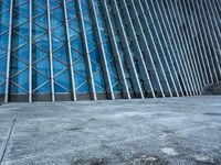 a building with several sections in the middle of it and a person standing outside on the side