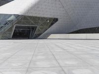 a man is riding his skateboard outside a building with a glass front door on a tile floor