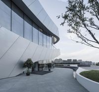 this modern looking building is designed as an oval - shaped structure with a curved roof and walls