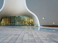 a courtyard area with pool area and reflections in windows, in the evening light at a business park