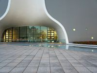 a courtyard area with pool area and reflections in windows, in the evening light at a business park