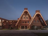 an unusual wooden building that is illuminated by led lights from the inside of the tower