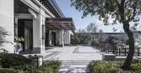 the view of a patio and a pavilion from the inside of a courtyard area in the sun