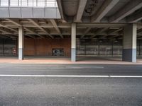 an empty parking garage with the doors closed in the center of it, next to a sidewalk