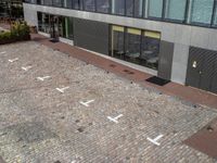 a man walking down a street near a building that has numbers on it, one number is white