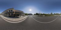 a fish - eye lens image of a school in a big town center with school building