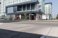 the view of buildings in front of an empty road in the city, with one building missing