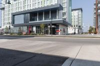 the view of buildings in front of an empty road in the city, with one building missing