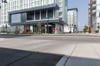 the view of buildings in front of an empty road in the city, with one building missing