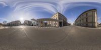 a spherical image is taken from the street of an industrial city, showing a half - way view and two large buildings