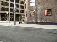 a motorcycle sits outside a building by a street sign with the words, new york