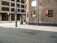 a motorcycle sits outside a building by a street sign with the words, new york