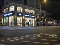 a mcdonalds on the corner of a busy street in an urban setting at night