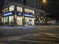 a mcdonalds on the corner of a busy street in an urban setting at night