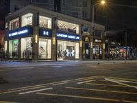 a mcdonalds on the corner of a busy street in an urban setting at night