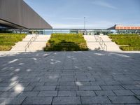 this is a view from outside the building of a stone walkway with steps leading to the front