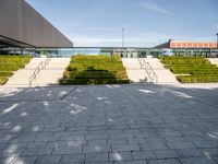 this is a view from outside the building of a stone walkway with steps leading to the front