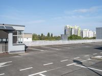 a empty parking lot in the middle of a large city with a view of a street