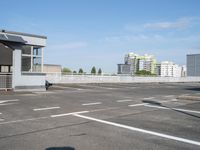 a empty parking lot in the middle of a large city with a view of a street