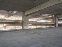 a parking garage full of cars and empty spaces to move forward through and off the car park