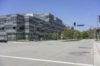 this is an image of a building in the city, with cars driving by it