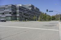 this is an image of a building in the city, with cars driving by it