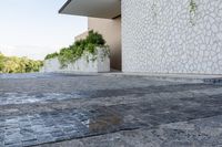 concrete walkway that has been painted grey and white with decorative pattern around it, outside an house