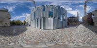 a mirror showing a 360 - view of an old building surrounded by modern architecture in the city