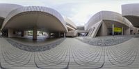 an abstract view of an architecturely looking place with a large round mirror in the middle