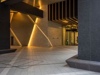 a hallway with columns on the wall that have led lights coming out of them and a door is behind the wall