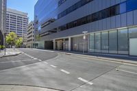 a corner of a street that has an arrow marked on it to the sidewalk leading towards a parking garage with a closed sign