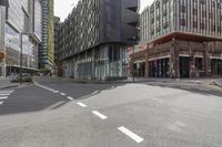 empty street with no people on a sunny day in downtown area of a city with high buildings