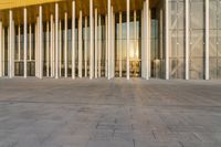 there is a very nice building that looks like a big glass building with columns on the front