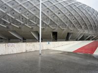 the entrance to a building in the city, with red paint on the ground and concrete wall, and white trims
