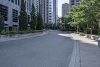 a car driving down an empty street lined with tall buildings and trees in the background