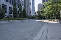 a car driving down an empty street lined with tall buildings and trees in the background