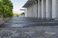 the walkway between two columns is made from pebbles and stone tiles to allow additional walkwaying