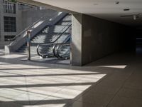 a large empty walkway with glass doors and escalators in front of it on an empty building